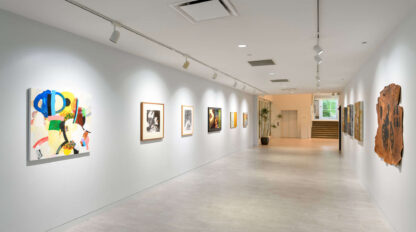 An art gallery with paintings hanging on the wall.