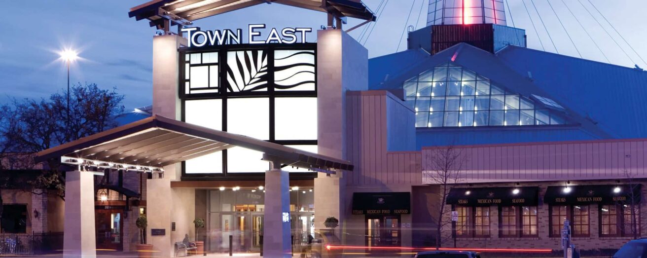 Twilight view of the town east mall entrance with illuminated signage.