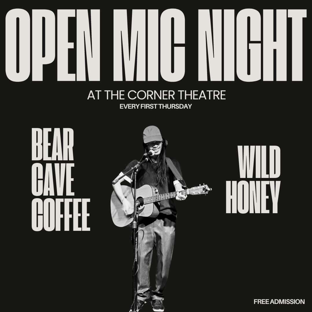 Musician playing guitar on stage under large "Open Mic Night" sign at the Corner Theatre. Text: "Bear Cave Coffee," "Wild Honey," "Free Admission.